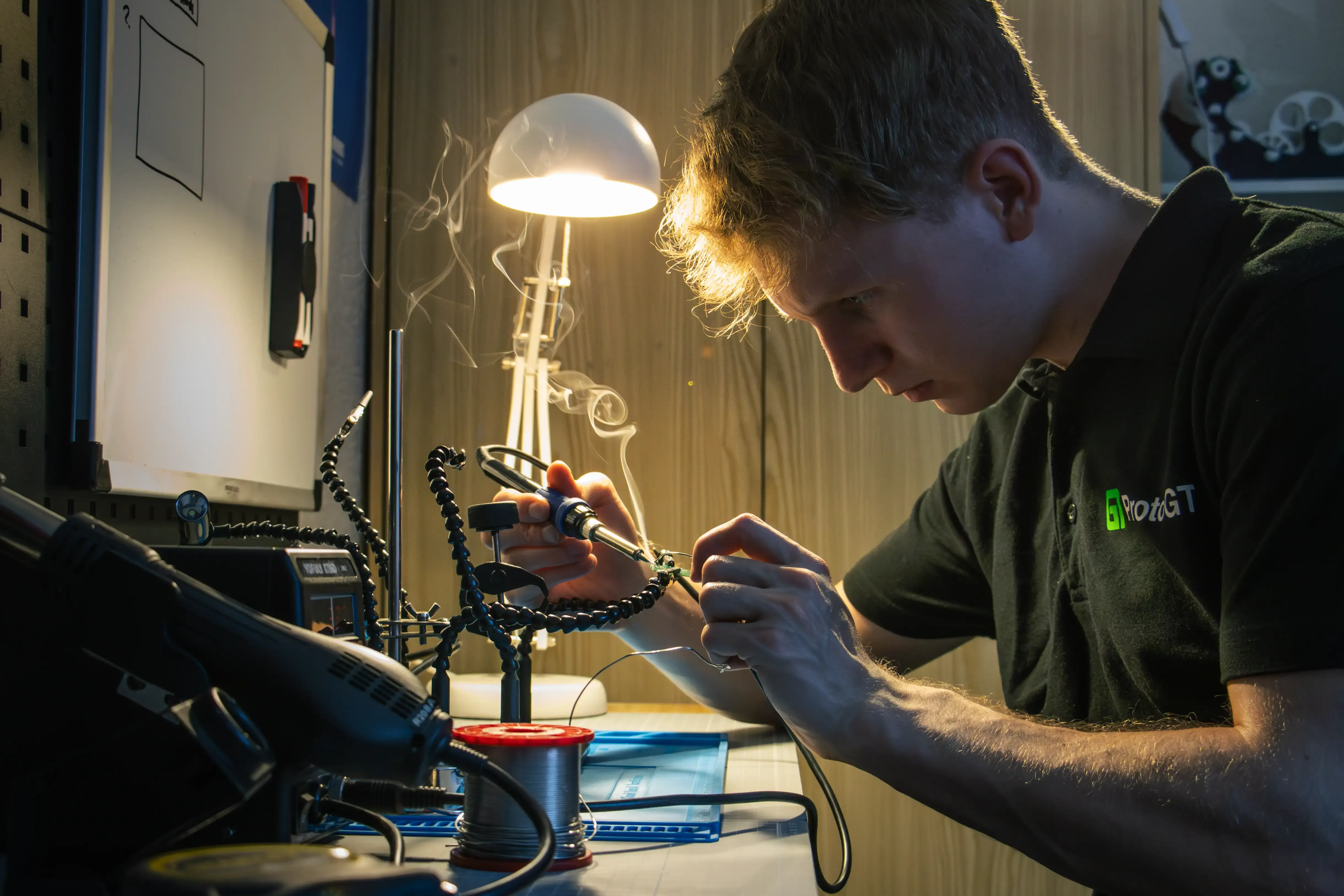 ProtoGT engineer soldering components onto a custom PCB
