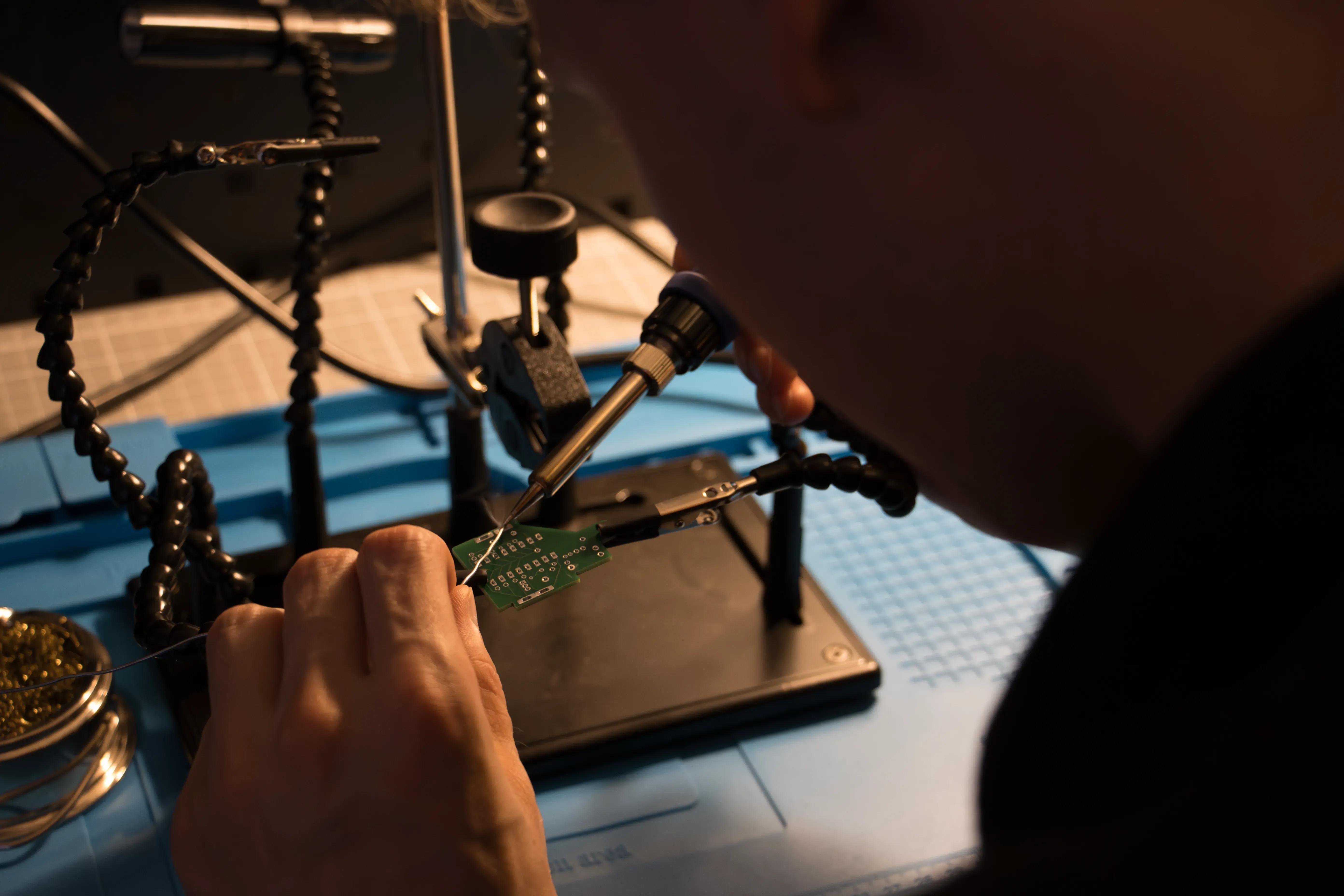 ProtoGT technician applying solder to a custom electronics assembly