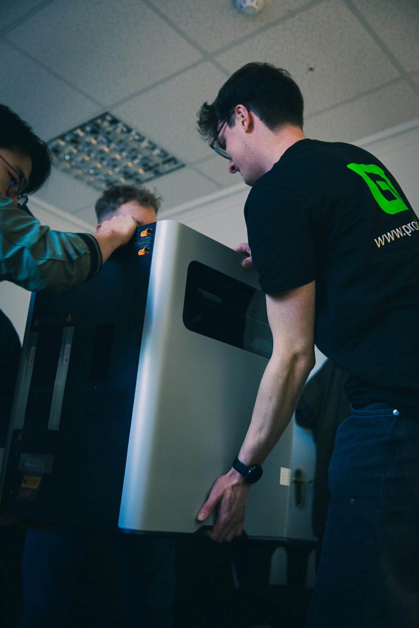 ProtoGT engineers installing a 3D printer in the workshop
