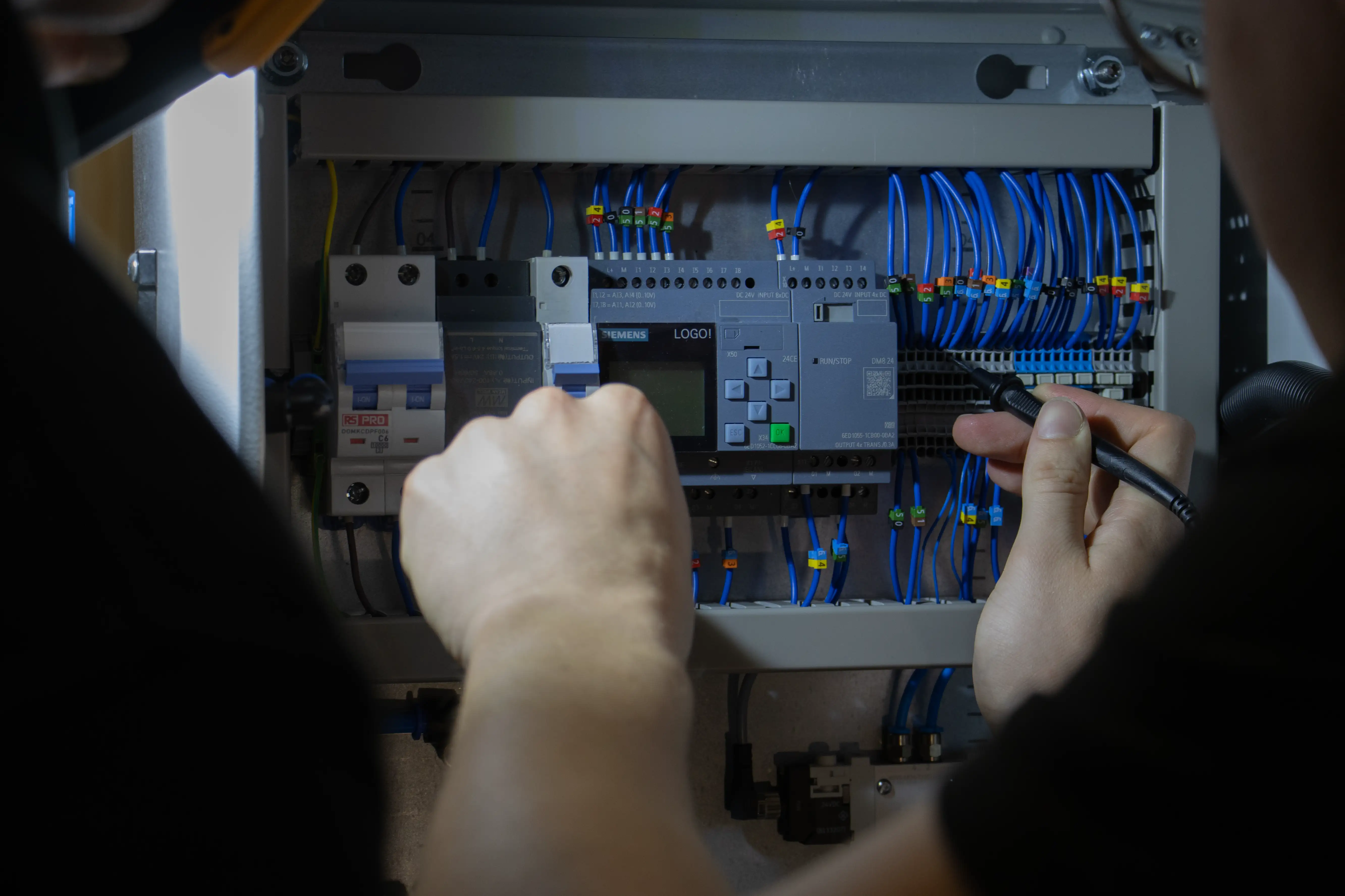 An engineer testing a carefully wired control system